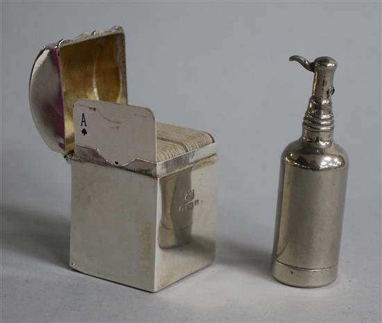 A silver miniature playing card box and a novelty writing companion